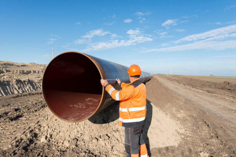 pipeline workers measuring tube length construction gas oil pipes