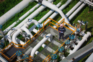 top view male worker inspection valve visual check record pipeline oil gas industry