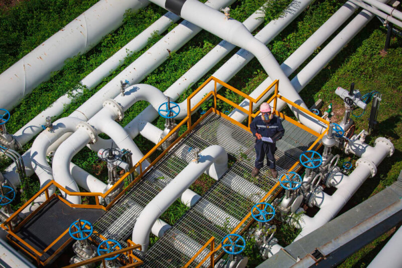 top view male worker inspection valve visual check record pipeline oil gas industry